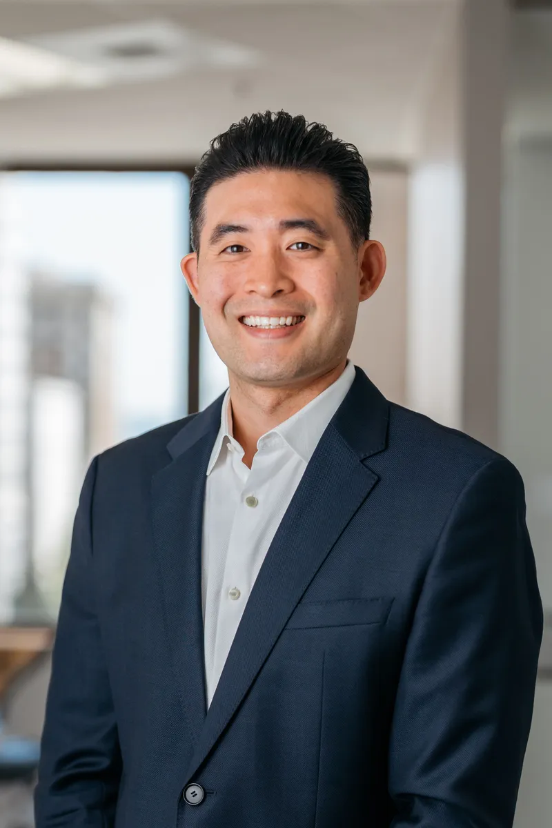 Charles Kim, DMD, smiling in his downtown Tacoma office